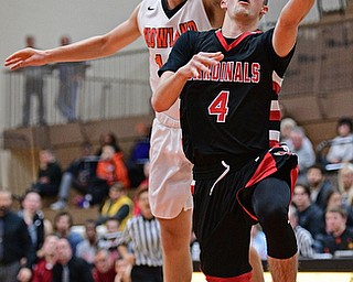 HOWLAND, OHIO - DECEMBER 9, 2016: Brandon McFall #4 of Canfield goes to the basket while being chased from behind by Michael Massucci #12 of Howland during the first half of their game Friday night at Howland High School. DAVID DERMER | THE VINDICATOR