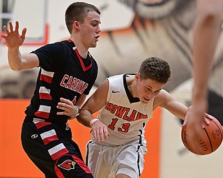 HOWLAND, OHIO - DECEMBER 9, 2016: Connor Tamarkin #13 of Howland stumbles while being bumped by Brandon McFall #4 of Canfield during the second half of their game Friday night at Howland High School. DAVID DERMER | THE VINDICATOR