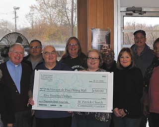 SPECIAL TO THE VINDICATOR
Members of Community Gardeners at St. Patrick Church, 1420 Oak Hill Ave., Youngstown, made beef vegetable soup recently using vegetables grown in the parish community garden. The proceeds of $500 from sale of the soup were given to St. Vincent dePaul Society dining hall to help provide food for the hungry of the Valley. Gardeners from left, are Christine Silvestri; Ann Lawson; Sherry Halt; the Rev. David Bergner, Youngstown Diocese; Tom Kapics, president of St. Vincent dePaul; Tom Williams; Pam Wrench; Amy Best; Shirlynne Ford, secretary of St. Vincent dePaul; Kathy Rothman; Carl Hall; Carol Smith; and Greg Davner.