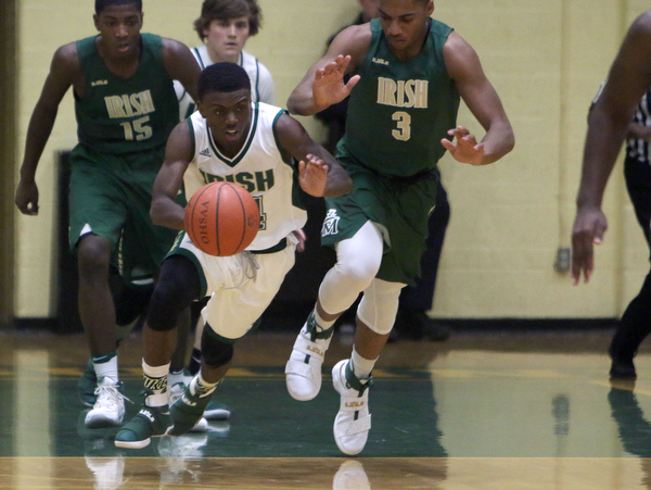 Ursuline's Dakota Hobbs (14) steals the ball from Akron St. Vincent-St. Mary's Jayvon Graves (3) during the first half of Friday nights matchup at Ursuline High School in Youngstown.   Dustin Livesay  |  The Vindicator