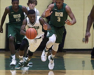 Ursuline's Dakota Hobbs (14) steals the ball from Akron St. Vincent-St. Mary's Jayvon Graves (3) during the first half of Friday nights matchup at Ursuline High School in Youngstown.   Dustin Livesay  |  The Vindicator