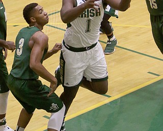 Ursuline's Anthony Howell (1) puts up a layup over Akron St. Vincent-St. Mary's DeAmonte' King (3) during the first half of Friday nights matchup at Ursuline High School in Youngstown.   Dustin Livesay  |  The Vindicator