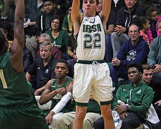 Ursuline's Vince Venzeio (22) puts up a 3-pointer while being defended by Akron's St.- Vincent St. Mary's Scott Walter (1) during the first half of Friday nights matchup at Ursuline High School in Youngstown.   Dustin Livesay  |  The Vindicator