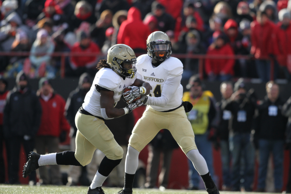 Wofford College Terrier junior quarterback Brandon Goodson (14) hands off to Wofford College Terrier senior fullback Lorenzo Long (7)during the first half as Youngstown State takes on Wofford College in the FCS quarterfinals at Stambaugh Stadium in Youngstown on Saturday, Dec. 10, 2016. Youngstown State won in double overtime, 30-23, advancing to the semifinals...(Nikos Frazier | The Vindicator)..