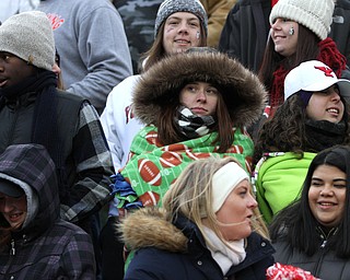 Sara O'Kane watches the game while wrapped in a football blanket during the first half as Youngstown State takes on Wofford College in the FCS quarterfinals at Stambaugh Stadium in Youngstown on Saturday, Dec. 10, 2016. Youngstown State won in double overtime, 30-23, advancing to the semifinals...(Nikos Frazier | The Vindicator)..