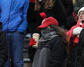 A student hides from the cold behind her scarf during the second half as Youngstown State takes on Wofford College in the FCS quarterfinals at Stambaugh Stadium in Youngstown on Saturday, Dec. 10, 2016. Youngstown State won in double overtime, 30-23, advancing to the semifinals...(Nikos Frazier | The Vindicator)..