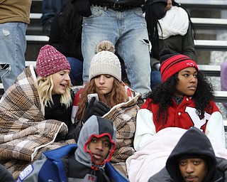 (from left) Ellie Pollock, senior, Whitney Winch, sophomore, and Chenera Lacey, senior, watch the game under blankets during the second half as Youngstown State takes on Wofford College in the FCS quarterfinals at Stambaugh Stadium in Youngstown on Saturday, Dec. 10, 2016. Youngstown State won in double overtime, 30-23, advancing to the semifinals...(Nikos Frazier | The Vindicator)..