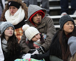 Carlos Trevino wraps his arms around Casey Gibbs as Mckenzie McMurray(left) and Helen Mei(right) watch the game during the second half as Youngstown State takes on Wofford College in the FCS quarterfinals at Stambaugh Stadium in Youngstown on Saturday, Dec. 10, 2016. Youngstown State won in double overtime, 30-23, advancing to the semifinals. ..(Nikos Frazier | The Vindicator)..