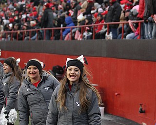 Youngstown State cheerleaders Destiny Ketchum(right) and Megan White(left) smile in the cold during the second half as Youngstown State takes on Wofford College in the FCS quarterfinals at Stambaugh Stadium in Youngstown on Saturday, Dec. 10, 2016. Youngstown State won in double overtime, 30-23, advancing to the semifinals...(Nikos Frazier | The Vindicator)..
