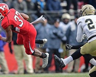 YOUNGSTOWN, OHIO - DECEMBER 10, 2016: Tevin McCaster #37 of YSU flies through the air after being tripped up by Terrance Morris #9 and Devin Watson #24 of Wofford during the first half of their FCS quarterfinal playoff game Saturday afternoon at Stambaugh Stadium. YSU won 30-23 in double overtime. DAVID DERMER | THE VINDICATOR
