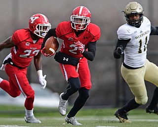 YOUNGSTOWN, OHIO - DECEMBER 10, 2016: Darien Townsend #21 of YSU runs with the ball in the open field after picking up a block from Donovan McWilson #23 on Blake Morgan #11 of Wofford during the first half of their FCS quarterfinal playoff game Saturday afternoon at Stambaugh Stadium. YSU won 30-23 in double overtime. DAVID DERMER | THE VINDICATOR