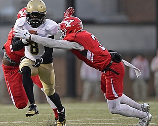 YOUNGSTOWN, OHIO - DECEMBER 10, 2016: Joe Newman #8 of Wofford is tackled by LeRoy Alexander #3 and Avery Moss #9 of YSU during the second half of their FCS quarterfinal playoff game Saturday afternoon at Stambaugh Stadium. YSU won 30-23 in double overtime. DAVID DERMER | THE VINDICATOR