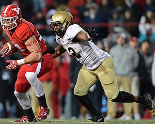 YOUNGSTOWN, OHIO - DECEMBER 10, 2016: Kevin Rader #83 of YSU runs with the football before being hit by Datavious Wilson #42 of Wofford during double overtime of their FCS quarterfinal playoff game Saturday afternoon at Stambaugh Stadium. YSU won 30-23 in double overtime. DAVID DERMER | THE VINDICATOR