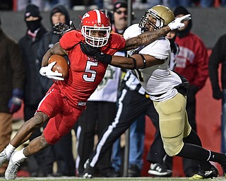 YOUNGSTOWN, OHIO - DECEMBER 10, 2016: Alvin Bailey #5 of YSU runs with the football while stiff arming Malik Rivera #31 of Wofford during double overtime of their FCS quarterfinal playoff game Saturday afternoon at Stambaugh Stadium. YSU won 30-23 in double overtime. DAVID DERMER | THE VINDICATOR