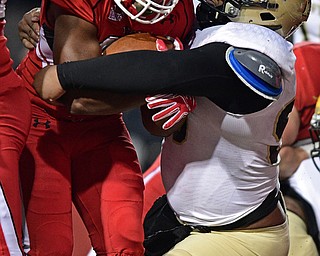 YOUNGSTOWN, OHIO - DECEMBER 10, 2016: Tevin McCaster #37 of YSU carries Miles Brown #90 of Wofford across the goal line to score a touchdown during double overtime of their FCS quarterfinal playoff game Saturday afternoon at Stambaugh Stadium. YSU won 30-23 in double overtime. DAVID DERMER | THE VINDICATOR