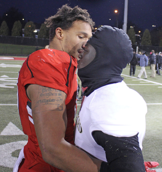 Youngstown State's Derek Rivers (11) hugs a tearful Joe Newman (8) of Wofford after the Penguins double overtime victory against the Terriers on Saturday afternoon at Stambaugh Stadium. Dustin Livesay  |   The Vindicartor  12/10/16  YSU.