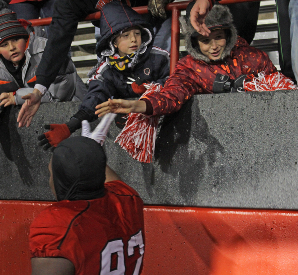 Alex Yoder (11,left) and David Williams (12) of Hubbard give high five to Youngstown State's Donald Mesier (92) after the Penguins double overtime victory against Wofford on Saturday afternoon at Stambaugh Stadium. Dustin Livesay  |   The Vindicartor  12/10/16  YSU.