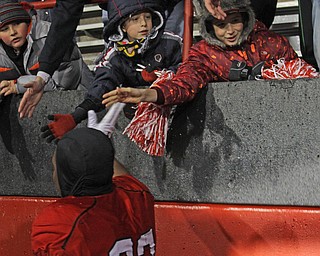 Alex Yoder (11,left) and David Williams (12) of Hubbard give high five to Youngstown State's Donald Mesier (92) after the Penguins double overtime victory against Wofford on Saturday afternoon at Stambaugh Stadium. Dustin Livesay  |   The Vindicartor  12/10/16  YSU.