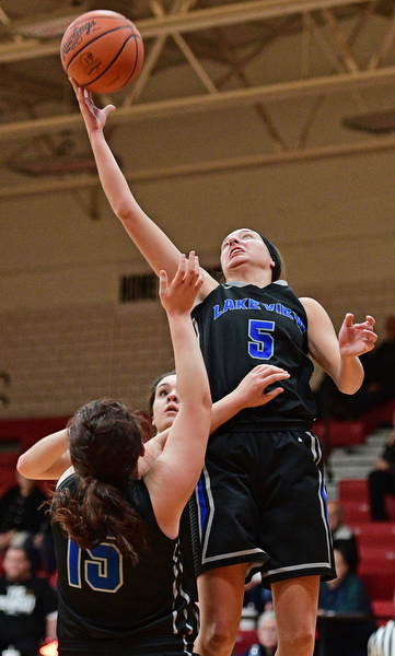 CANFIELD, OHIO - DECEMBER 12, 2016: Jensen Silbaugh #5 of Lakeview jumps to secure a rebound away from teammates Leah Franks #15 and Annie Pavlansky #10 during the first half of their game Monday night at Canfield High School. DAVID DERMER | THE VINDICATOR