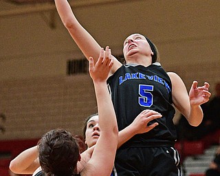 CANFIELD, OHIO - DECEMBER 12, 2016: Jensen Silbaugh #5 of Lakeview jumps to secure a rebound away from teammates Leah Franks #15 and Annie Pavlansky #10 during the first half of their game Monday night at Canfield High School. DAVID DERMER | THE VINDICATOR