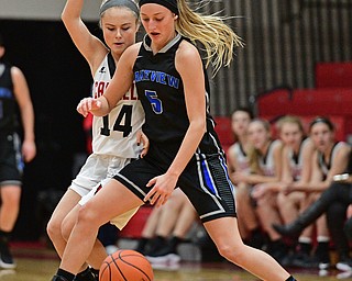 CANFIELD, OHIO - DECEMBER 12, 2016: Jensen Silbaugh #5 of Lakeview dribbles up court while being tightly guarded by Emerson Fletcher #14 of Canfield during the first half of their game Monday night at Canfield High School. DAVID DERMER | THE VINDICATOR