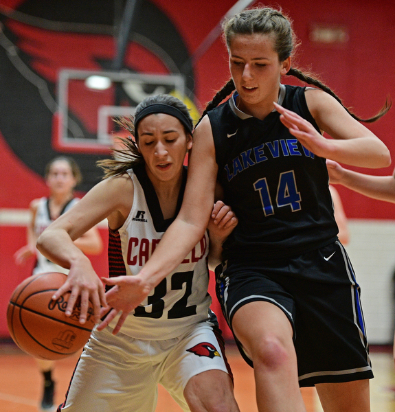 CANFIELD, OHIO - DECEMBER 12, 2016: Christina Rivera #32 of Canfield dribbles the ball while protecting it from the hand of Camie Becker #14 of Lakeview during the second half of their game Monday night at Canfield High School. DAVID DERMER | THE VINDICATOR