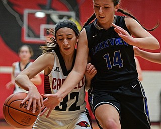 CANFIELD, OHIO - DECEMBER 12, 2016: Christina Rivera #32 of Canfield dribbles the ball while protecting it from the hand of Camie Becker #14 of Lakeview during the second half of their game Monday night at Canfield High School. DAVID DERMER | THE VINDICATOR