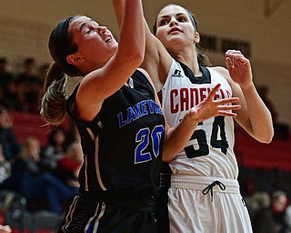 CANFIELD, OHIO - DECEMBER 12, 2016: Lindsay Carnahan #20 of Lakeview goes to the basket while Serena Sammarone #54 of Canfield goes for the block during the second half of their game Monday night at Canfield High School. DAVID DERMER | THE VINDICATOR