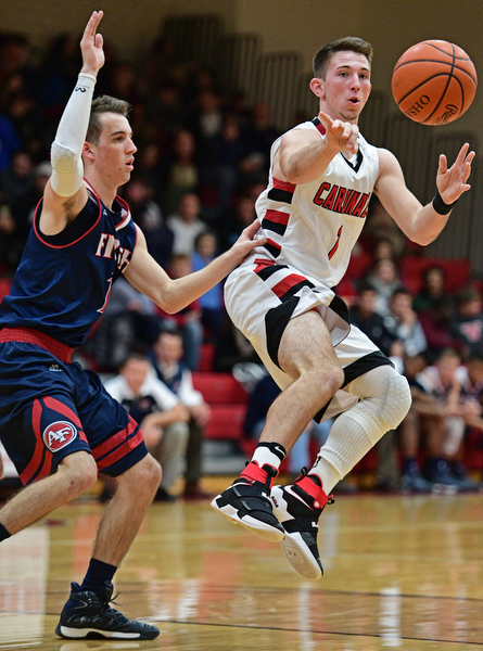CANFIELD, OHIO - DECEMBER 12, 2016: Jake Cummings #1 of Canfield passes the ball while being pressured by Ryan Sheffield #13 of Fitch during the second half of their game Tuesday night at Canfield High School. DAVID DERMER | THE VINDICATOR