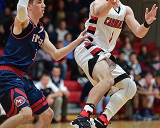 CANFIELD, OHIO - DECEMBER 12, 2016: Jake Cummings #1 of Canfield passes the ball while being pressured by Ryan Sheffield #13 of Fitch during the second half of their game Tuesday night at Canfield High School. DAVID DERMER | THE VINDICATOR