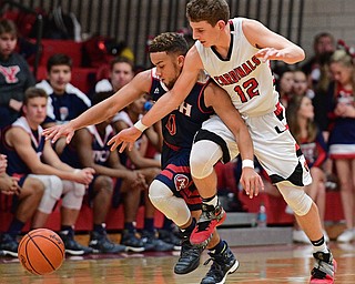 CANFIELD, OHIO - DECEMBER 12, 2016: Randy Smith #0 of Fitch and Ethan Kalina #12 of Canfield jockey for position while chasing after the loose ball during the second half of their game Tuesday night at Canfield High School. DAVID DERMER | THE VINDICATOR