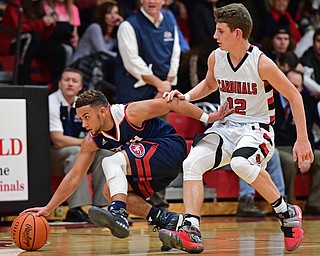 CANFIELD, OHIO - DECEMBER 12, 2016: Randy Smith #0 of Fitch gains control the ball while being pressured by Ethan Kalina #12 of Canfield during the second half of their game Tuesday night at Canfield High School. DAVID DERMER | THE VINDICATOR