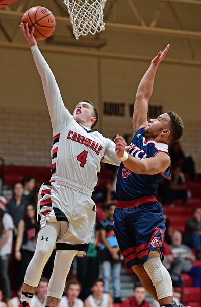 CANFIELD, OHIO - DECEMBER 12, 2016: Brandon McFall #4 of Canfield goes to the basket while Randy Smith #0 of Fitch goes for the block during the second half of their game Tuesday night at Canfield High School. DAVID DERMER | THE VINDICATOR
