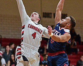 CANFIELD, OHIO - DECEMBER 12, 2016: Brandon McFall #4 of Canfield goes to the basket while Randy Smith #0 of Fitch goes for the block during the second half of their game Tuesday night at Canfield High School. DAVID DERMER | THE VINDICATOR