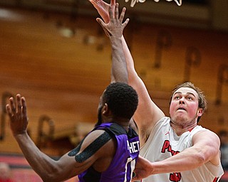 YOUNGSTOWN, OHIO - DECEMBER 13, 2016: Jorden Kaufman #32 of YSU goes to the basket while Marvin Prochet #11 of Niagara goes for the block during the first half of their game Wednesday night at the Beeghly Center. DAVID DERMER | THE VINDICATOR