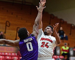 YOUNGSTOWN, OHIO - DECEMBER 13, 2016: Cameron Morse #24 of YSU puts up a flower while bing pressured by Chris Barton #0 of Niagara during the first half of their game Wednesday night at the Beeghly Center. DAVID DERMER | THE VINDICATOR