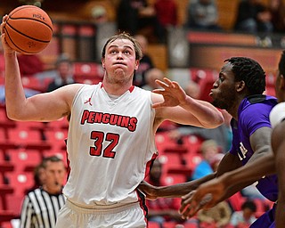 YOUNGSTOWN, OHIO - DECEMBER 13, 2016: Jorden Kaufman #32 of YSU drives on Ali Tew #30 of Niagara during the first half of their game Wednesday night at the Beeghly Center. DAVID DERMER | THE VINDICATOR