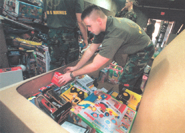 CPL James Dagnan of Cleveland is among Marines boxing up toys that were donated for the corps Toys for Tots campaign Friday at the Youngstown Air Reserve Base in Vienna. December 11, 1998 (Bruce Palmer | The Vindicator)