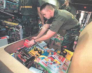 CPL James Dagnan of Cleveland is among Marines boxing up toys that were donated for the corps Toys for Tots campaign Friday at the Youngstown Air Reserve Base in Vienna. December 11, 1998 (Bruce Palmer | The Vindicator)