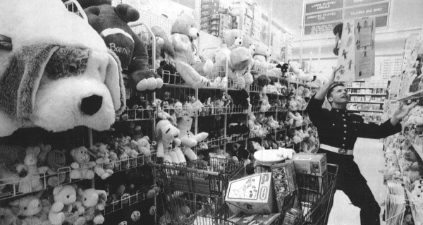SGT. John Landgraff a marine form Boardman stretches to get a toy down at Toy-R-US. He was shopping for the Toys for Pots Program. Toys-R-US donated the toys for the program. December 13, 1994