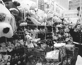 SGT. John Landgraff a marine form Boardman stretches to get a toy down at Toy-R-US. He was shopping for the Toys for Pots Program. Toys-R-US donated the toys for the program. December 13, 1994