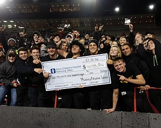 Neighbors | Submitted.Cardinal Mooney students celebrate their win on and off the field by holding a check for the total amount raised by both schools for Akron Children’s Hospital Mahoning Valley.