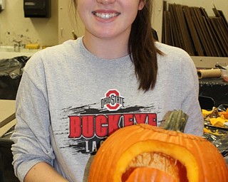 Neighbors | Abby Slanker.Canfield High School art club member Sarah Miller proudly displayed her pumpkin carving during the club’s Creative Carving event on Oct. 27.