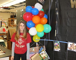 Neighbors | Abby Slanker.Canfield High School senior physics student Maura Kennedy proudly displayed her group’s “Up” mobile, complete with colorful balloons, on Mobile Mania Day Nov. 2.