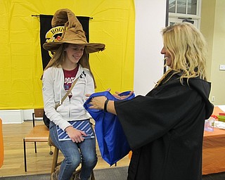 Neighbors | Alexis Bartolomucci.Alannah Hatzel reached into the bag Jen Kuczek was holding to pick out a tie and see what Harry Potter House she would be assigned to during the Hogwarts Potion Class at the Poland library on Nov. 10.