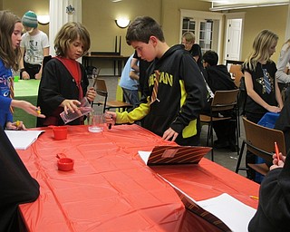 Neighbors | Alexis Bartolomucci.Children at the Hogwarts Potion Class on Nov. 10 at the Poland library mixed together different elements to make potions.