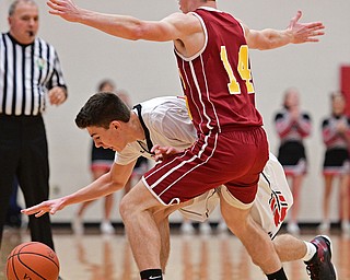GIRARD, OHIO - DECEMBER 16, 2016: Austin O'Hara #133of Girard dribbles while being cut off by Pat Brennan #14 of Mooney during the first half of their game Friday night at Girard High School. DAVID DERMER | THE VINDICATOR
