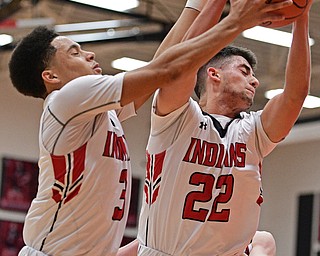 GIRARD, OHIO - DECEMBER 16, 2016: Anthony Graziano, right, #22 and Anthony Backus #3 of Girard work together to secure a rebound during the first half of their game Friday night at Girard High School. DAVID DERMER | THE VINDICATOR
