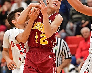 GIRARD, OHIO - DECEMBER 16, 2016: John Mikos #12 of Mooney reaches for the basketball while being tightly guarded by Austin Clausell #2 of Girard during the first half of their game Friday night at Girard High School. DAVID DERMER | THE VINDICATOR
