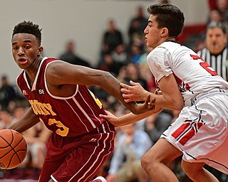 GIRARD, OHIO - DECEMBER 16, 2016: Sonny Rodriguez #23 of Mooney drives on Austin Clausell #2 of Girard during the second half of their game Friday night at Girard High School. DAVID DERMER | THE VINDICATOR